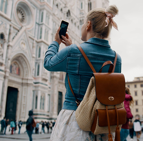 Photo of a lady taking a photo of a cathedral