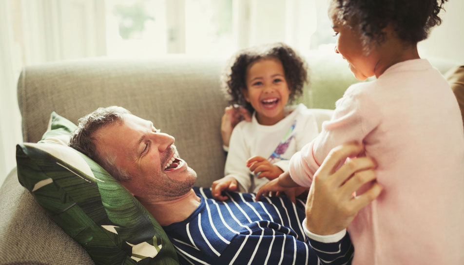 Children laughing with dad