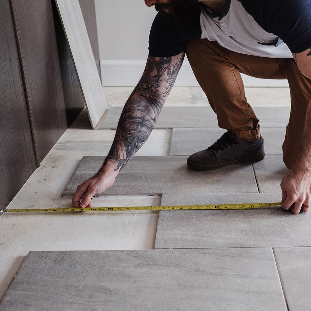 Man doing DIY measuring floor